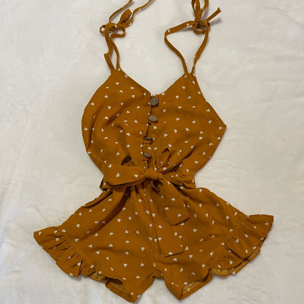 Orange romper with white hearts